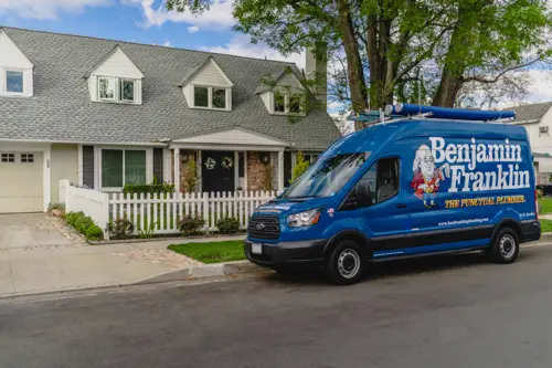 Closeup of a Benjamin Franklin Plumbing van outside a home in Orlando FL
