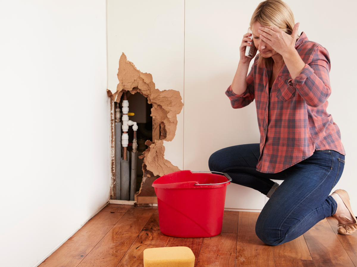 woman calling plumber because of major leak