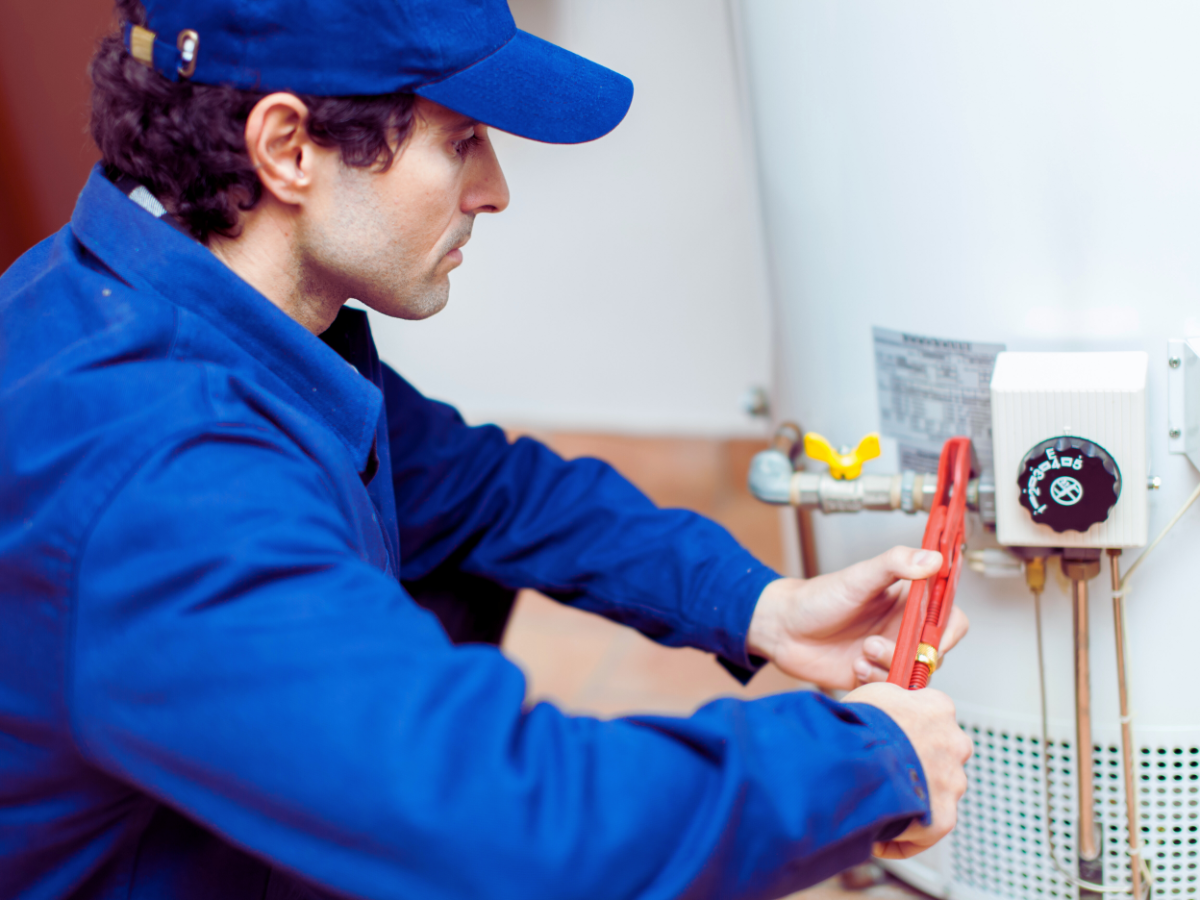 plumber performing hot water heater repairs