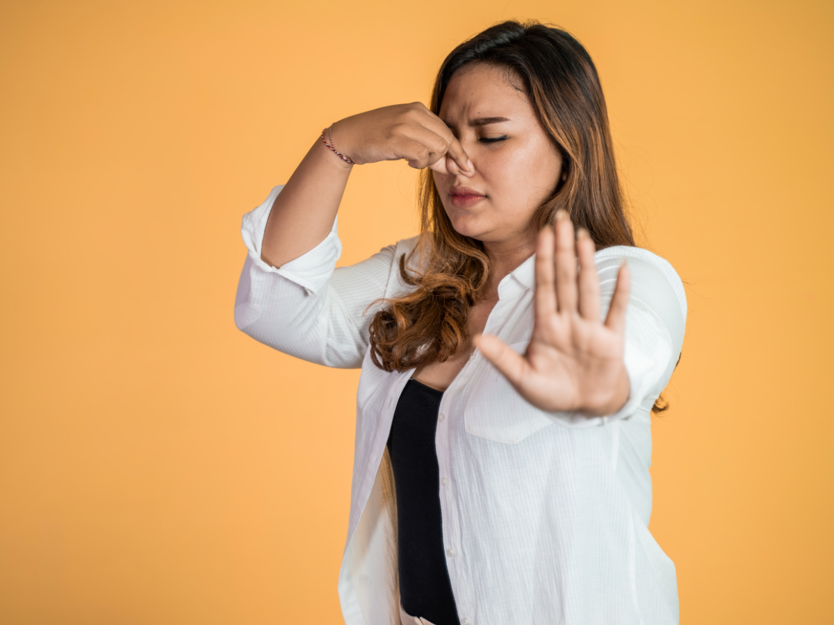 Homeowner holding nose because of sewer smell
