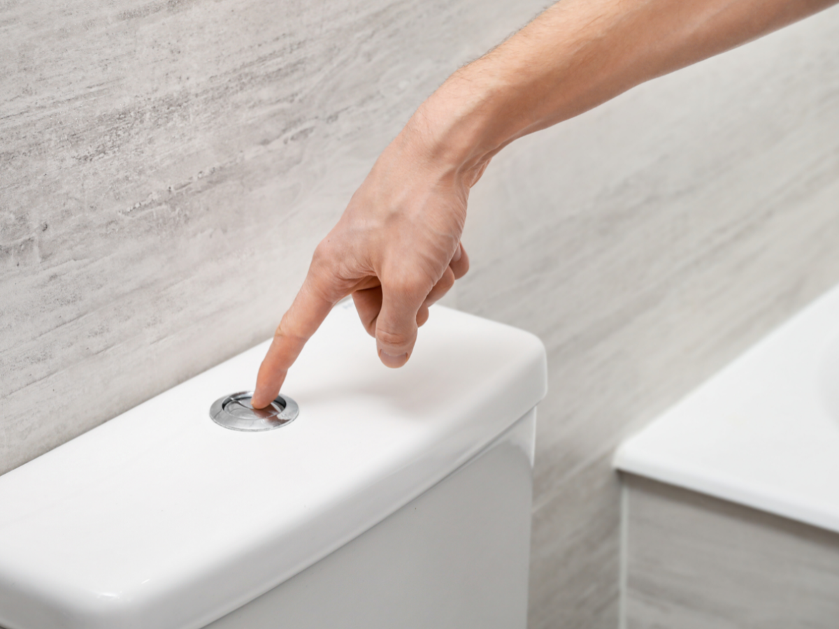 Homeowner flushing a slow toilet