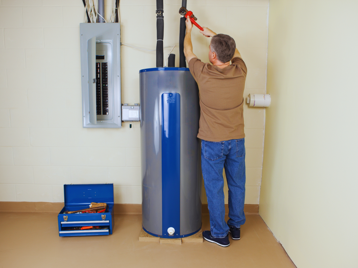 Plumber fixing water heater thats making noise